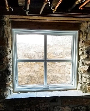 Closeup of Pella replacement basement window in West Chester underground railroad home.