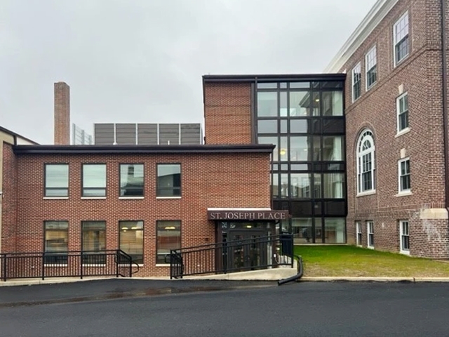 Addition of St. Joseph's place with customized black frame windows. 