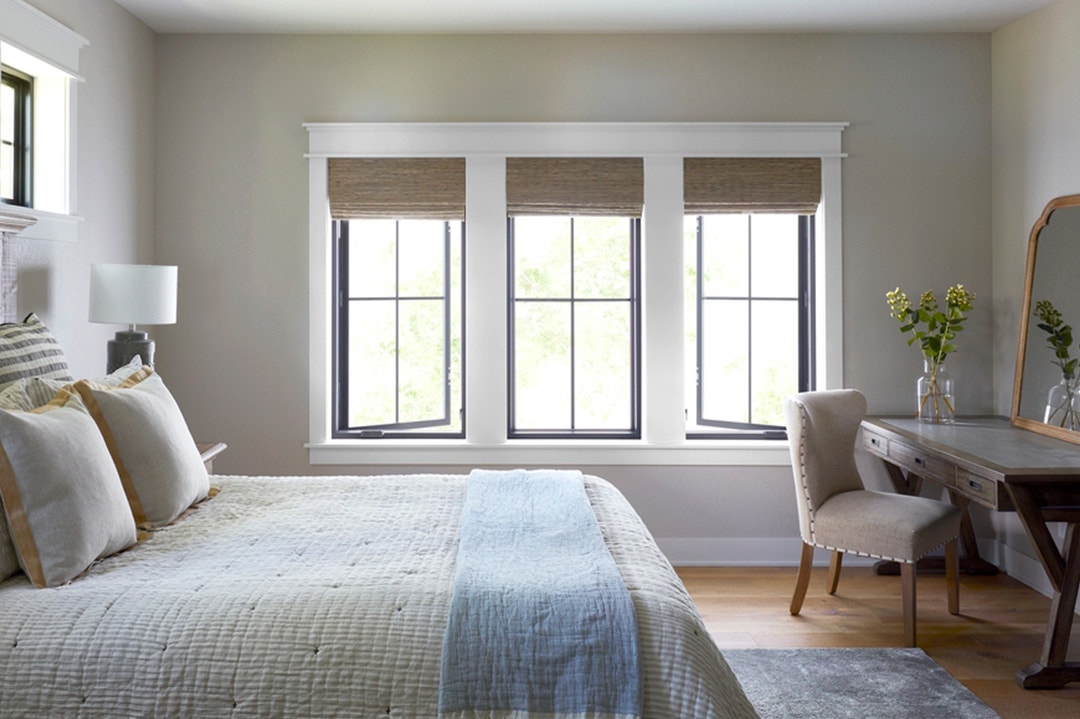 black casement windows with white trim in bedroom