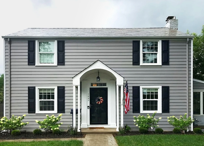 Grey upper Arlington home with white frame single-hung windows. 
