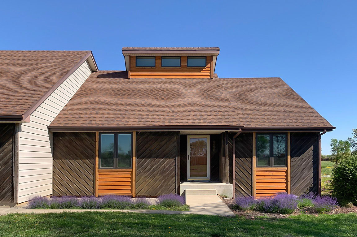  A modern home exterior showcasing new windows after replacement, emphasizing topeka window replacement.