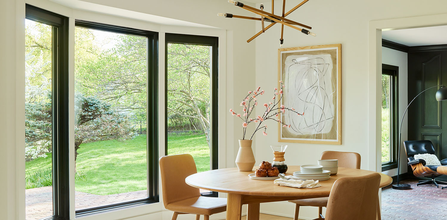 Austin dining room with a round table, bay window, and modern decor.