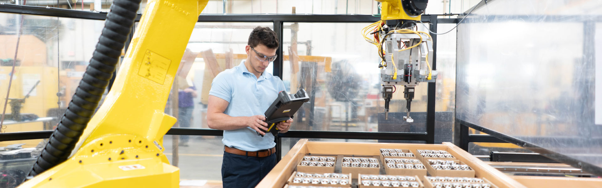 an engineer working on the pella robotic elements in the factory