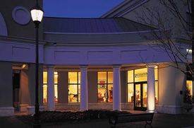 Outside view of storefront at night time.