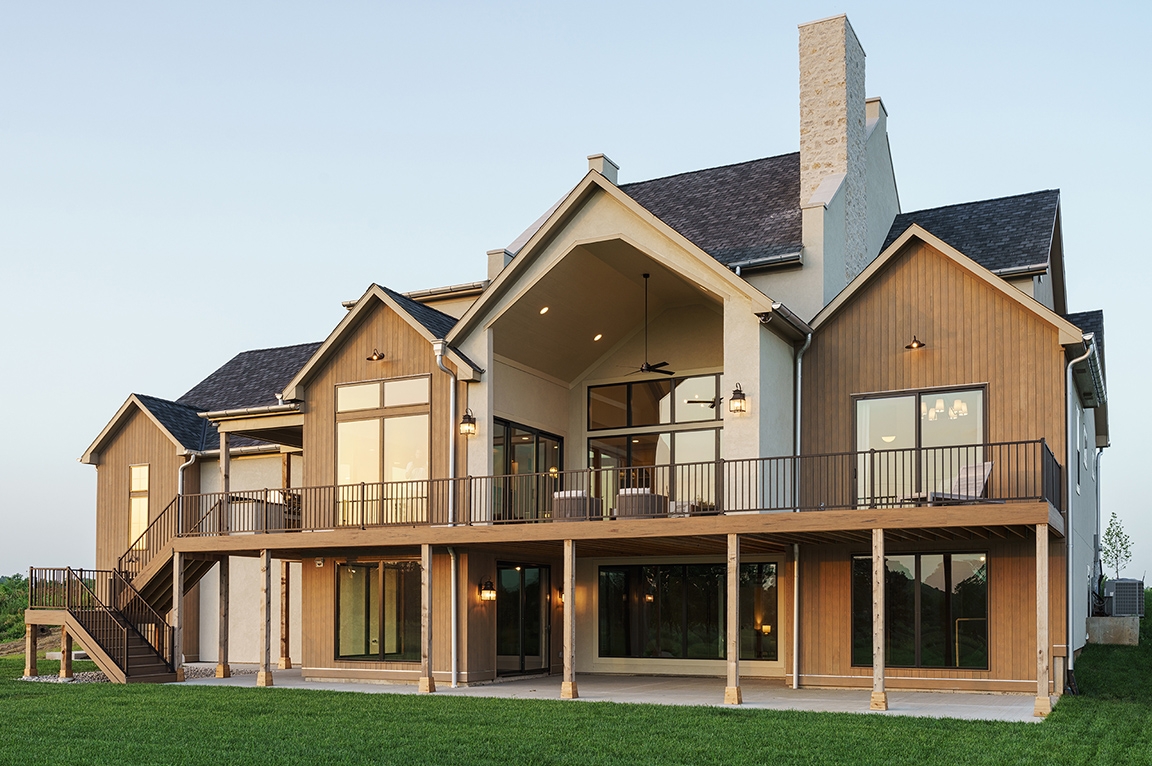 Backyard of new construction home in Kansas City with newly installed black Pella fiberglass windows.