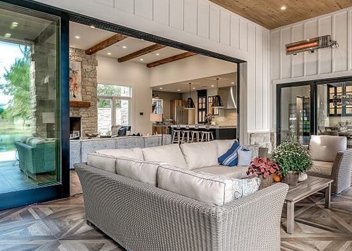 outdoor furniture in front of an open black multi-slide patio door