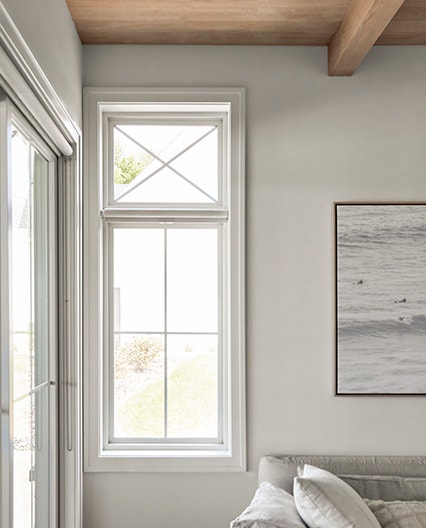 White casement window lets in natural light in living room.