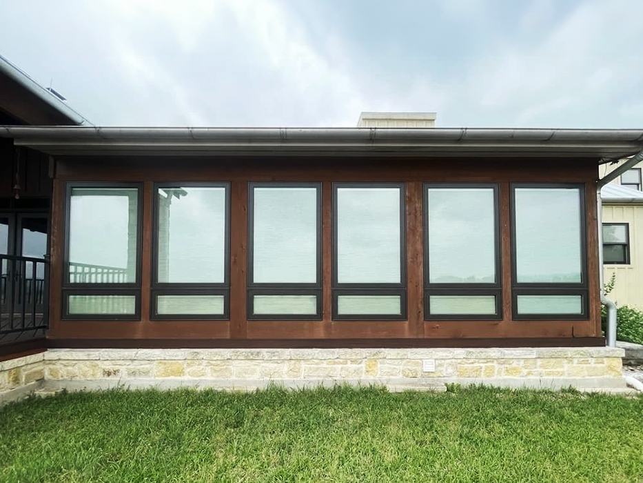 Outside of Bandera sunroom with newly installed Pella windows with built-in shades.