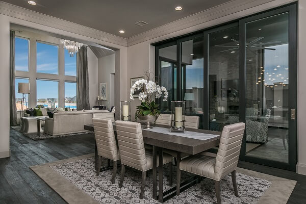 Elegant dining room has large multi-slide patio door connecting to the patio
