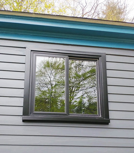 Newly installed black window brings modern flair to Great Barrington home.