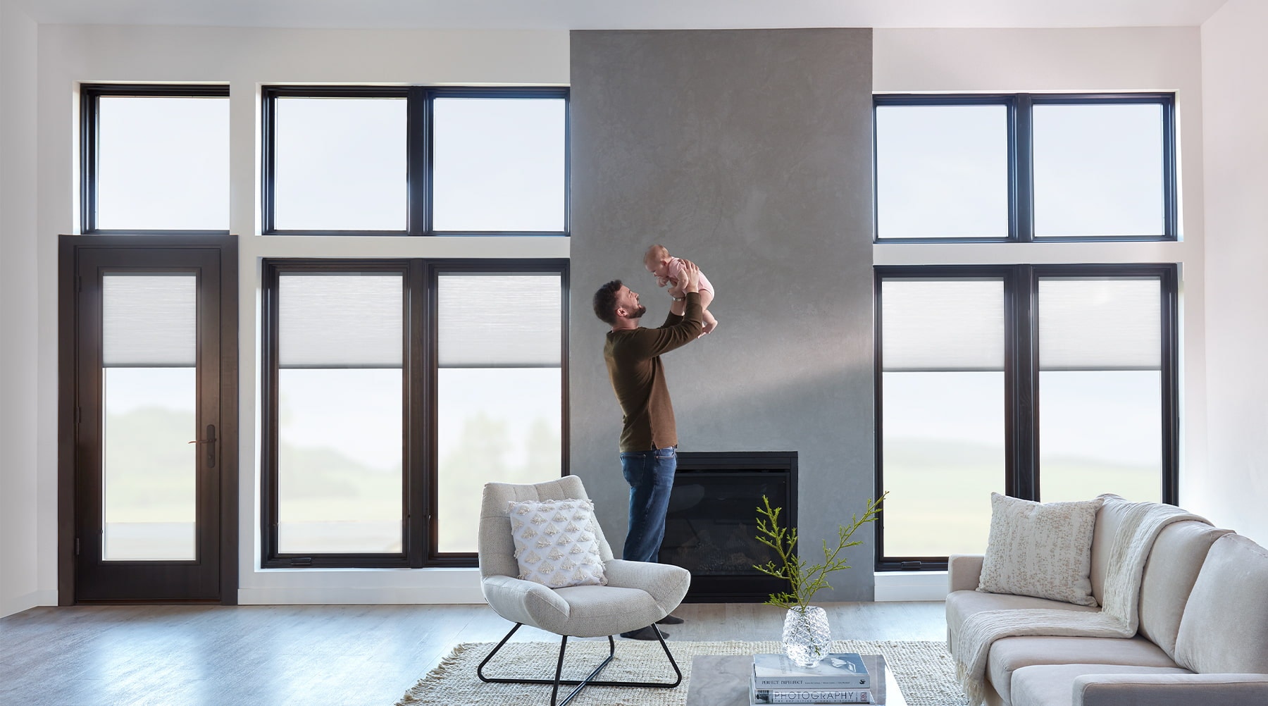 Dad and baby in living area with soundproof windows.