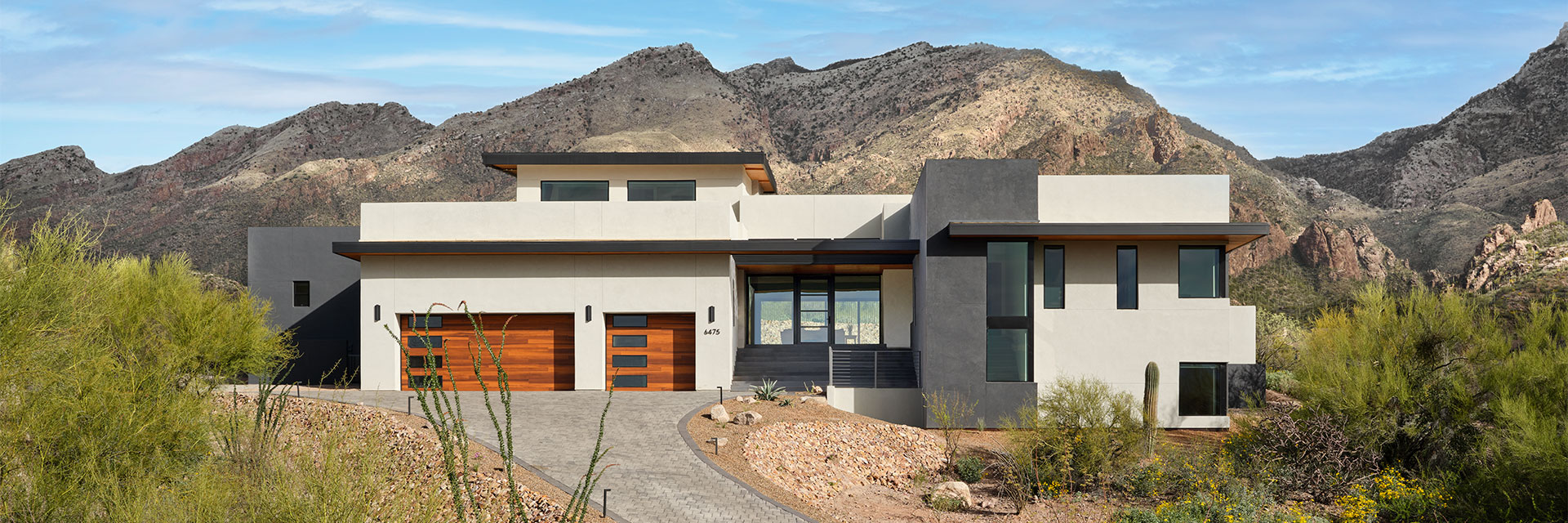 two red-stained wood garage doors on a contemporary southwestern home