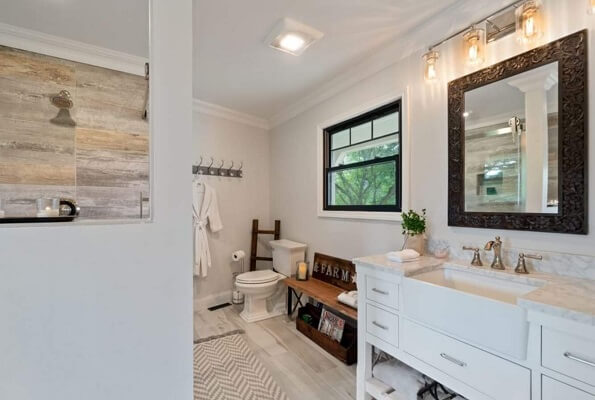 Black double-hung window with top row grille pattern in farmhouse style bathroom