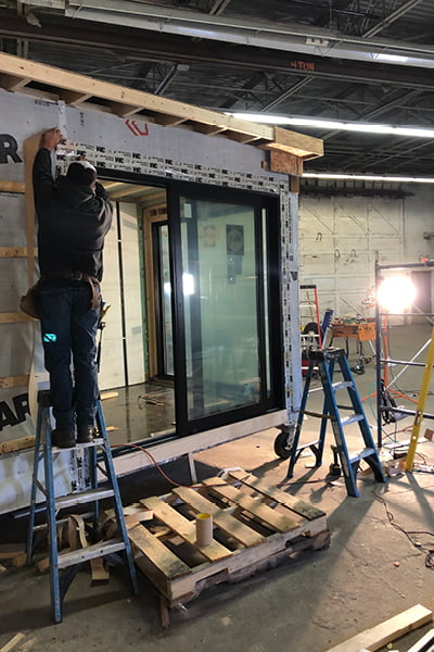 construction worker installing lifestyle series windows on tiny house