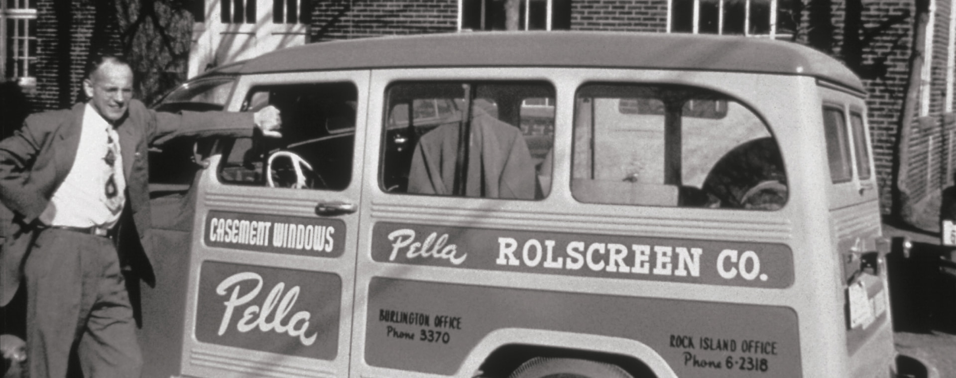 Pete Kuyper standing next to an original Pella delivery truck.
