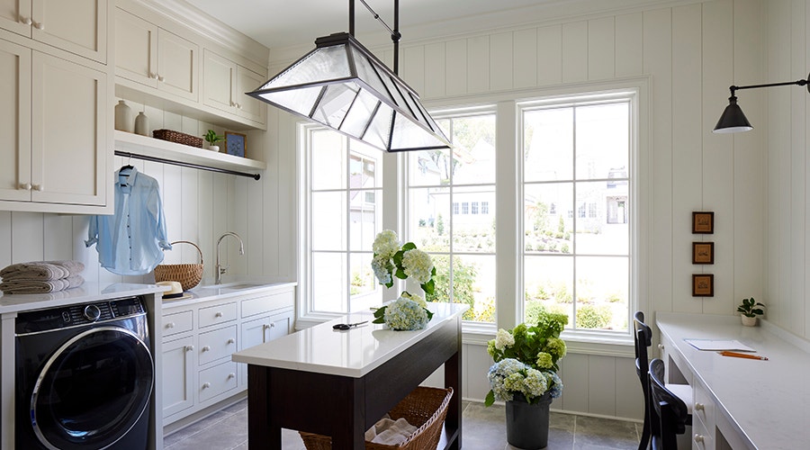fixed windows on the other side of a folding table with gardenias in a vase on the table.