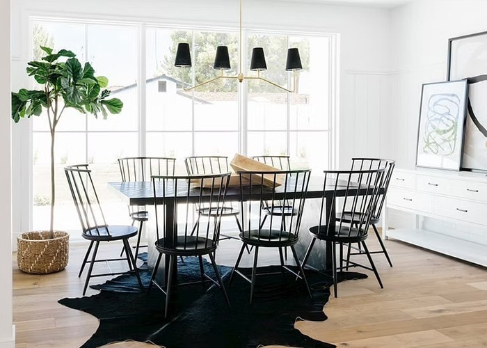 A contemporary black dining room adds drama to this all-white dining room