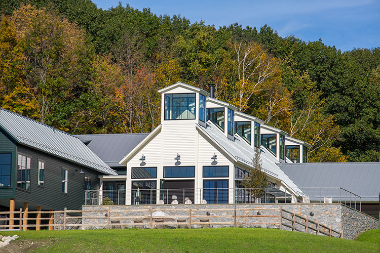 Outside view of Berkshire Farmhouse with large black windows.