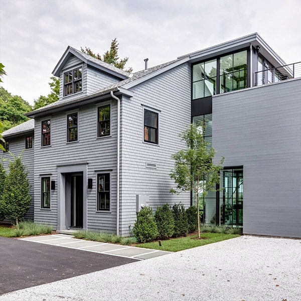 gray home with black windows and gabled dormers