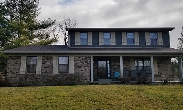 Curbside view of Okeana home with outdated windows in need of replacement.