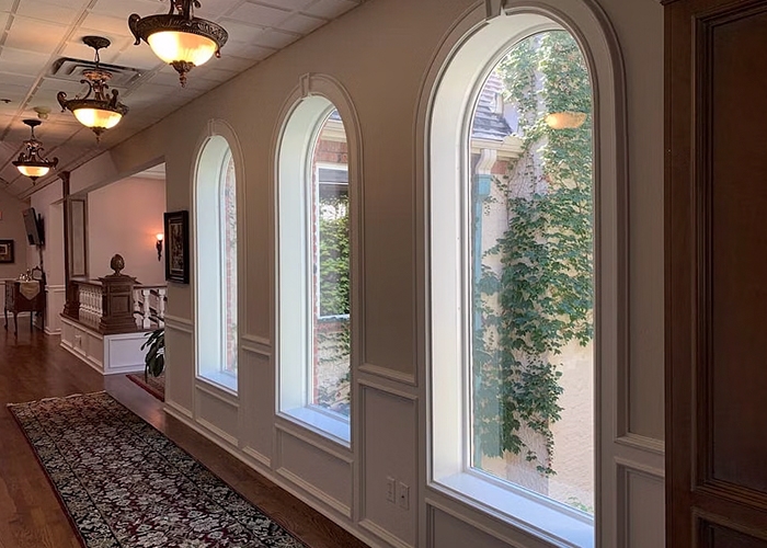 Interior image of a hallway in the Norman Education building with arched windows.