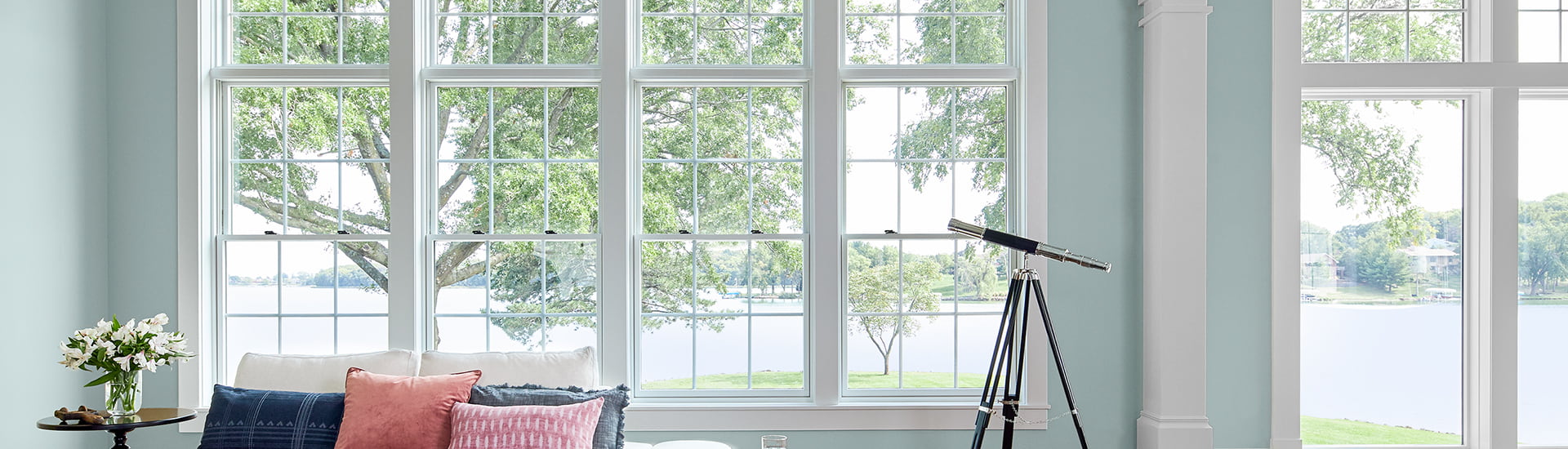 three wood double-hung windows not only bring in natural light, but also give a beautiful view of the lake