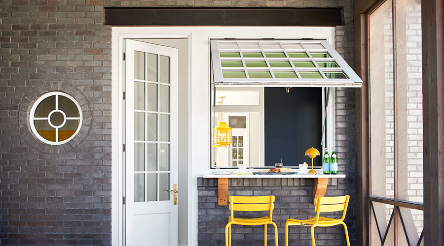 a large white window is open next to a 3/4 light hinged door, also in white