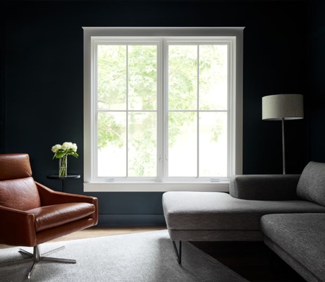 two white casement windows on a black wall