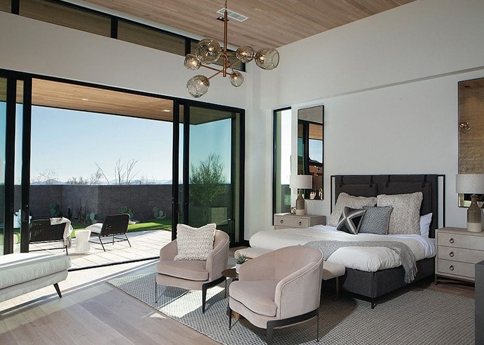 Scottsdale, Arizona home master bedroom and a multi-slide door opening to an outdoor patio