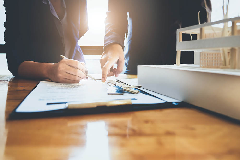 Mortgage Loan Officer meeting with clients to review jumbo loan options.