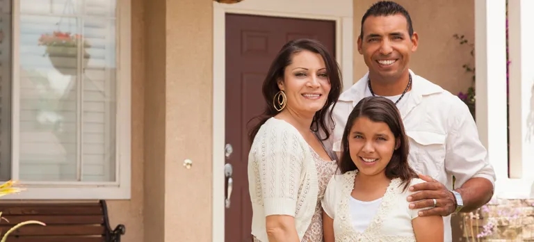 Husband, wife and daughter smiling