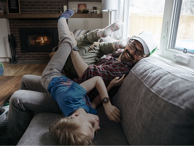 Father & son playing on the couch