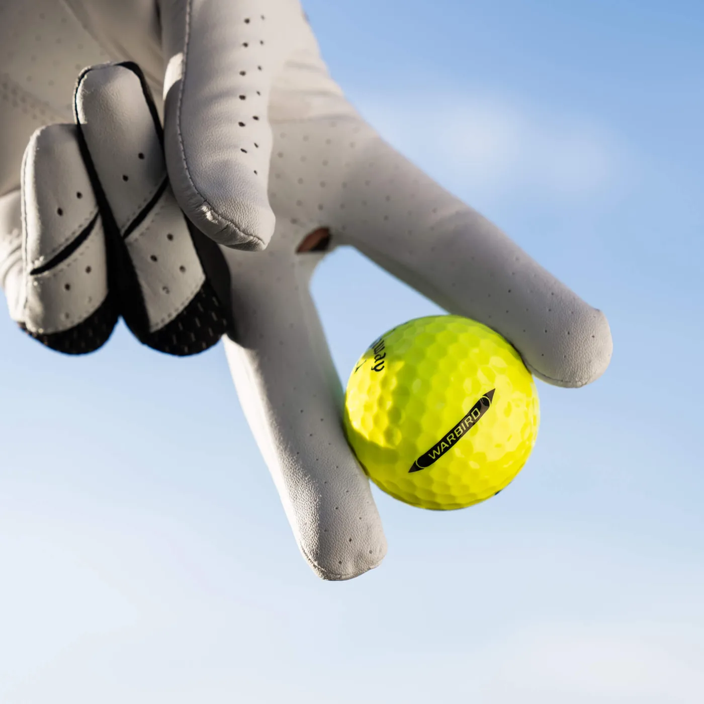 Callaway Warbird Distance+ Yellow golf ball lifestyle view