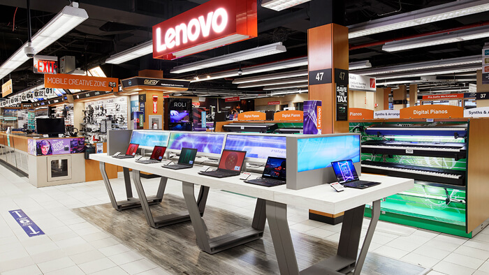 A photo of Lenovo digital product display and overhead signage.