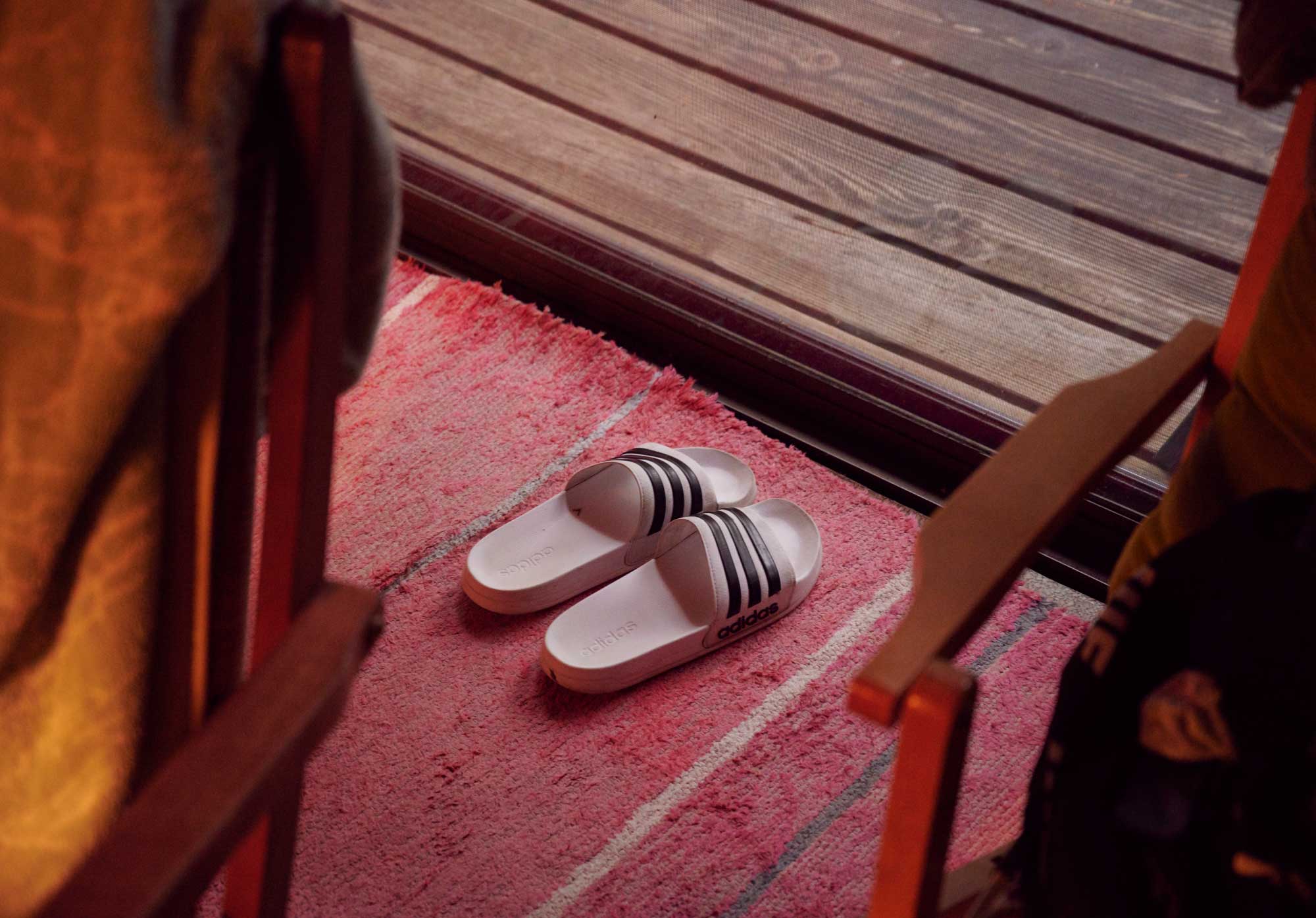 A pair of sandals on a red floor.