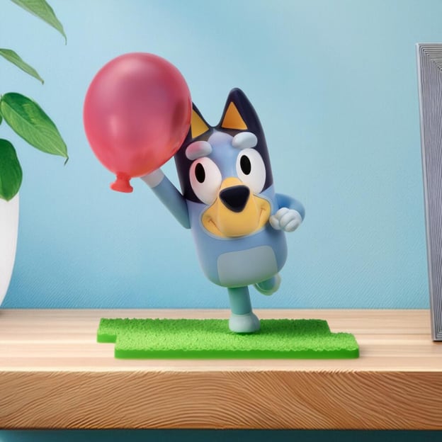 Bluey Collector Figure holding a red balloon. 