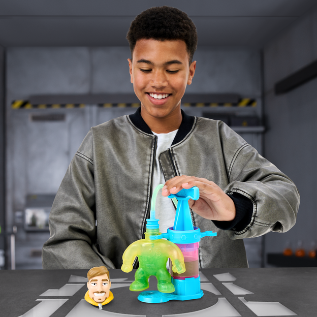 Young teen filling up the MrBeast Lab Creation Station Toy with liquid.