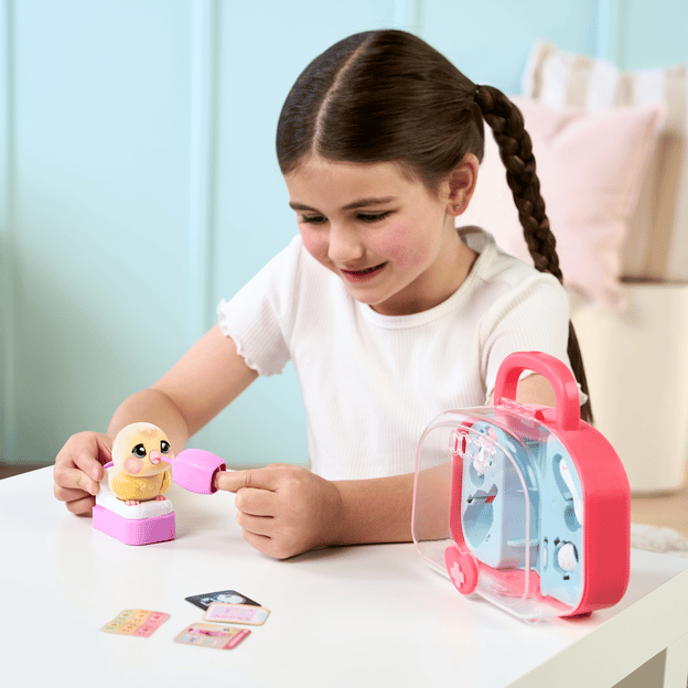 Young girl feeding a little bird toy. 