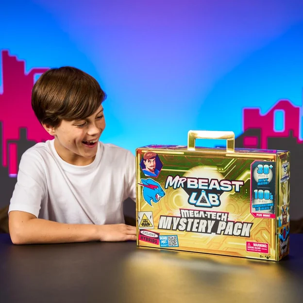 Young boy holding a MrBeast Mega Tech Mystery Pack box.