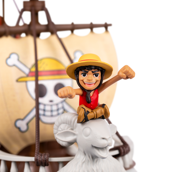 Close up of one piece mini action figure sitting on the front of a ship.