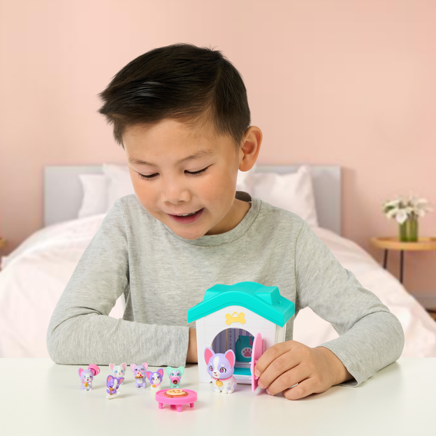 Little boy opening the door of a Mama Surprise Families Playset. 