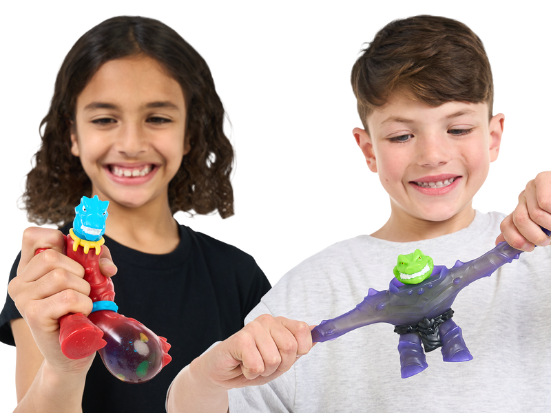 Two boys squeezing and stretching a heroes of Goo Jit Zu toy. 