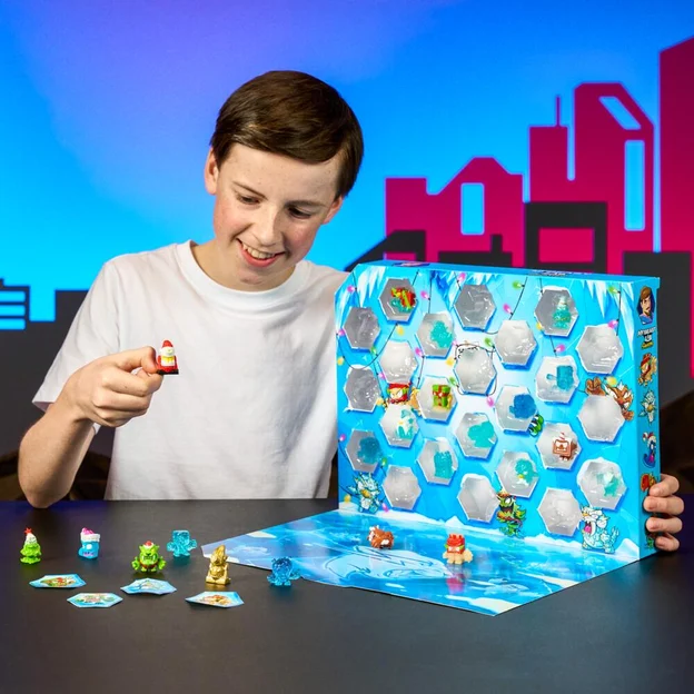 Young boy playing with his MrBeast Lab Swarms advent calendar.
