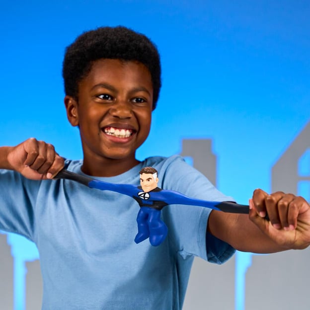Young boy stretching a Marvel Mister Fantastic Goo Jitzu toy. 