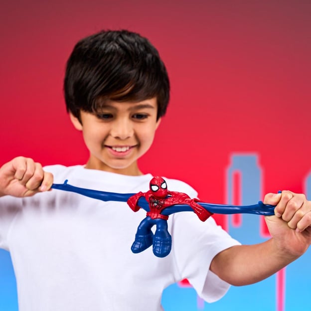 Young boy stretching a Marvel Goo Jitzu spiderman toy.