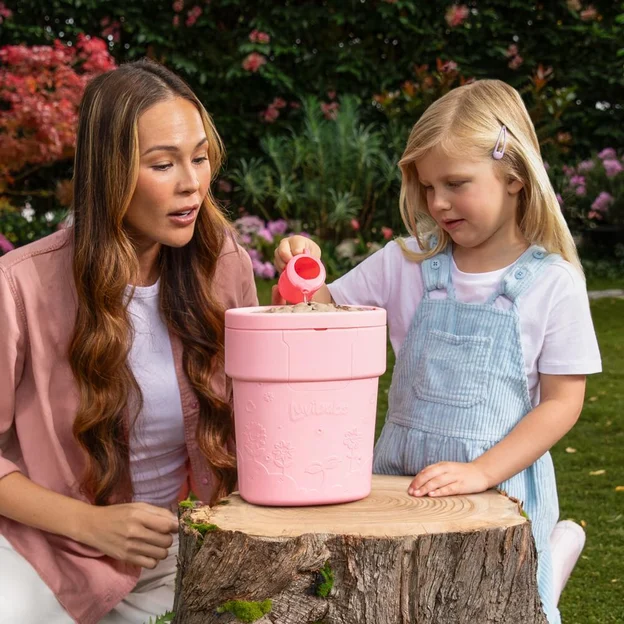 Mother and daughter pouring water into Luvibubs toy pot.