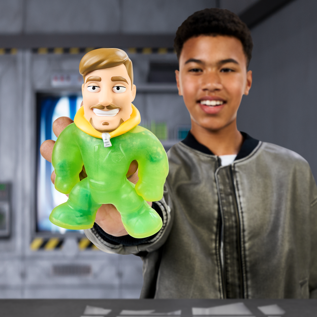 Young teen holding out the MrBeast Lab creation Station toy in his right hand.