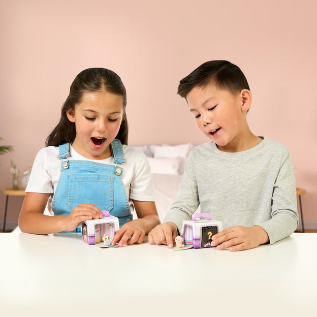 Little boy and girl revealing their Mama Surprise Families toys. 