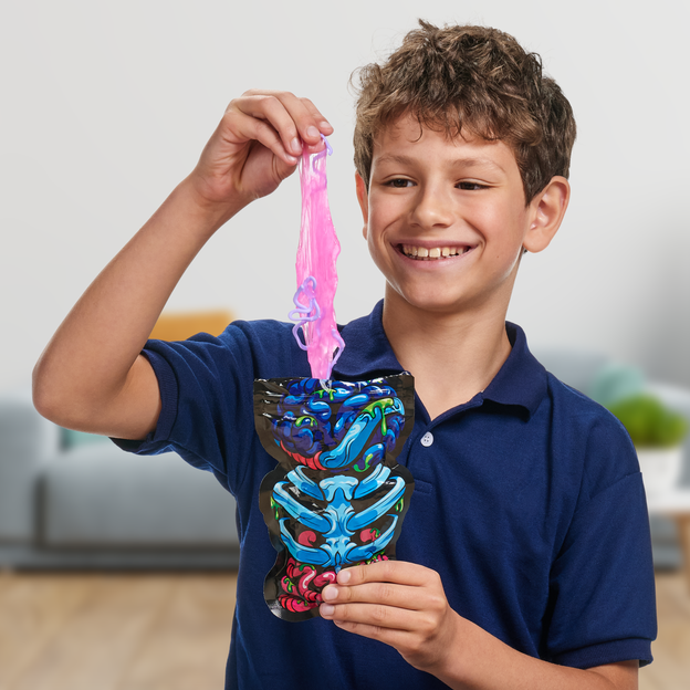 Boy holding pink gooey slime from his Treasure X Dissection Mini Alien toy.