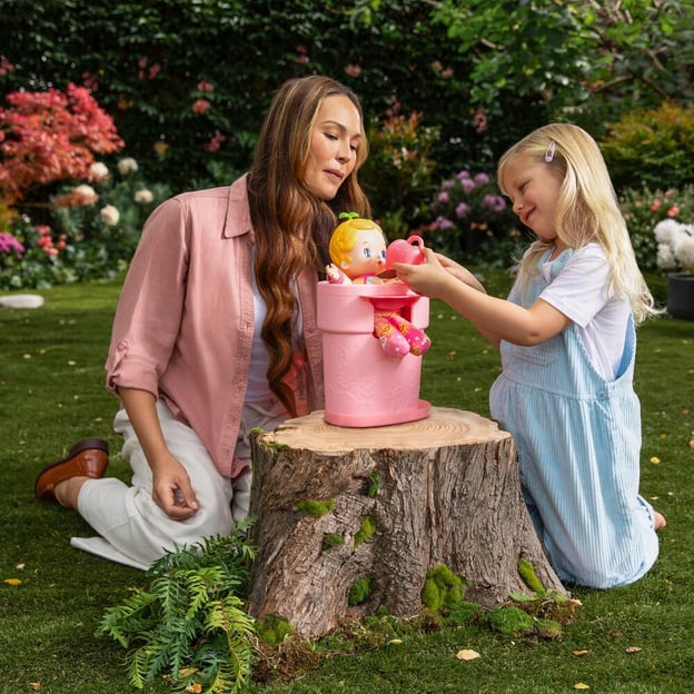 Mother and daughter playing with a pink Luvibubs Doll toy. 